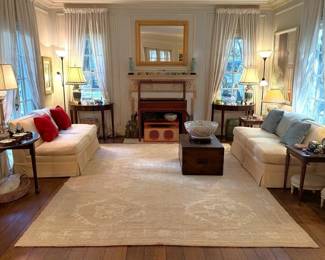 The “Perfect” living room!  Caitlin Wilson antique Oushak carpet, pair of down armless sofas, pair of demi-lune tables and antique trunk coffee table.  All adorned with treasures from around the world!