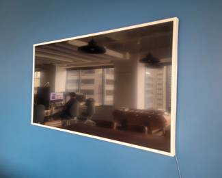 Large flat screen Samsung TV in white frame