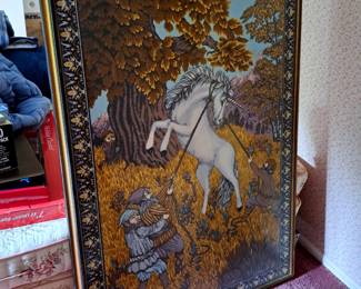 large antique tapestry framed under glass