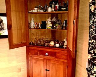 Cupboard open showing collectibles.
