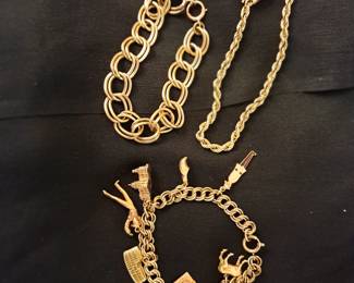 One 14 kt gold charm bracelet with one charm, One 10 kt gold charm bracelet with 10, 14, and 18 kt gold charms and a 14 kt gold bracelet.