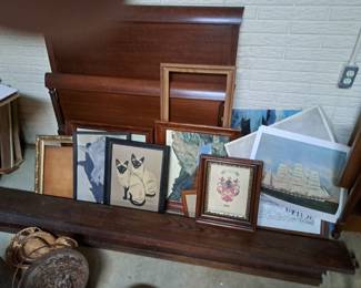 Old paintings, prints and single bed at rear