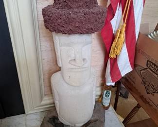 large cement or other composition material with lava rock hat and rock base Easter Island statue