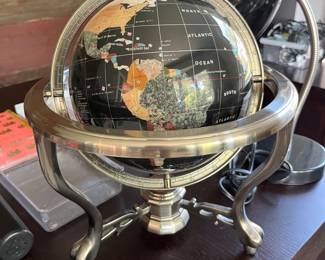 Semi-precious stone globe on silver-toned metal base.