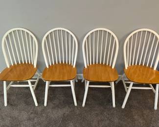 Four farmhouse-style kitchen chairs.