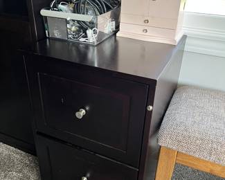 Two-drawer wood filing cabinet.