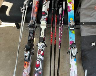 Downhill snow skis by K2, Nautica, and Fischer.