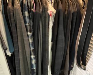 Extensive selection of men’s clothing, including jackets, collared shirts, and hats.
