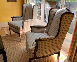 Pair of Louis XV style wingback armchairs with carved wood frames