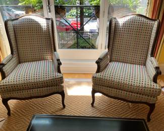 Pair of Louis XV style wingback armchairs with carved wood frames