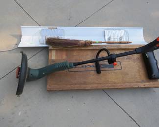 Lot 460. Shop creeper, electric weed whacker, broom, and light