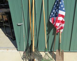 Lot 349. Long-handled tools, fishing rods, and an American flag