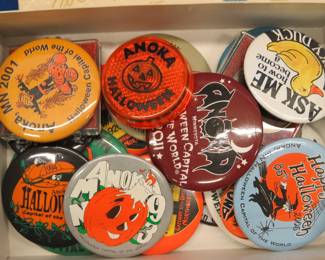 Lot 242. Anoka Halloween pinbacks and two 75th-anniversary coins in an old chocolate box