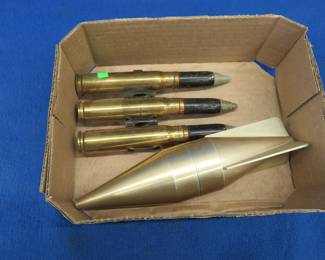 Lot 193. Three inert belted 20mm rounds and a homemade replica projectile