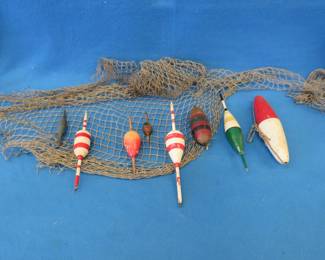 Lot 303. Antique fishing bobbers and a net