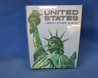 Lot 300. US stamp album with lots of stamps