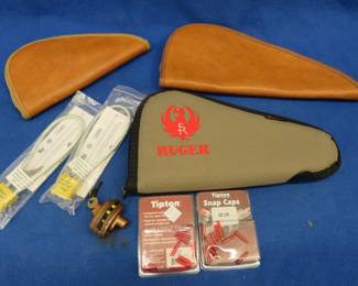 Lot 184. Three soft pistol cases, two packages of 22 Snap Caps, and three gun locks