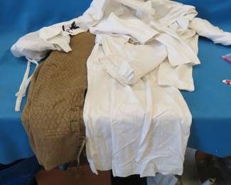 Lot 488. Two Naval shirts and two Naval pants and a vintage pair of brown pants.  Includes tote.