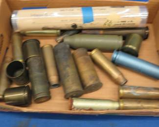 Lot 89. Military cartridge casings and a replica newspaper from 1878
