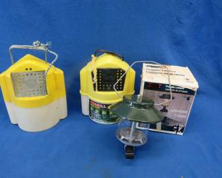 Lot 203. Coleman propane lantern that appears to be unused in an open box and two bait buckets
