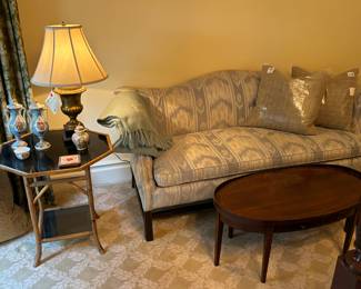 Chippendale sofa, assorted throw pillows, gilt table lamp w shade, bamboo side table 