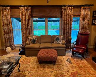84” upholstered sofa, tufted ottoman from Baker Furn Co, Cordovan leather chair & ottoman, Soleil hand woven rug, glass top coffee table, mahogany music/magazine rack 