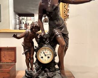 19th century bronze shelter figural mantle clock , enamel dial below women and child on marble base. Francis Moreau 1857-1930