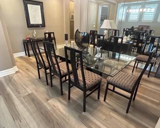 Glass top dining set with contemporary black base and ten dining chairs.  Table is 42x84
