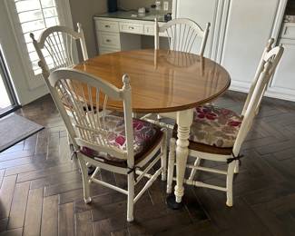 Ethan Allen dining table with drop sides and four chairs.  Table is 43" across