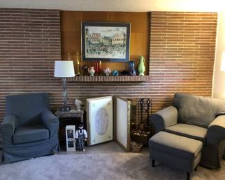 Arm Chairs, Lamps, Dolls, Wedding Goen in Box, Fire Iron Set, Basket of Matches, Bix of Sea Shells. On Fireplace Mantel: Candlesticks, Roseville Vase, Art Class, Pike Place Market Picture.