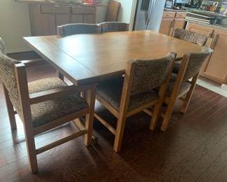 Solid wood dining room table with 8 chairs (featuring 6 in image). 