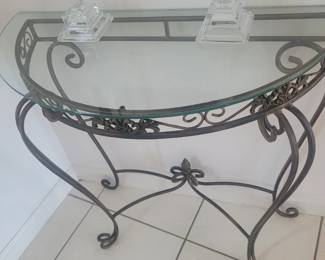 Half round metal table with a glass top