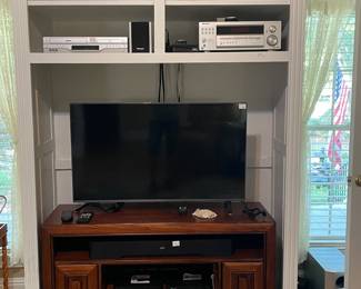 Large white cabinet, TV and TV cabinet, Pioneer DVD player, Toshiba VHS/DVD, 
Pioneer subwoofer, Kenwood speakers (2)...