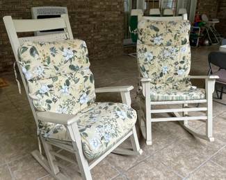 Two white rockers with cushions