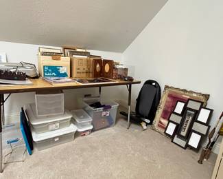 Lots of great picture frames, long table, fishing rods and metal file cabinet.