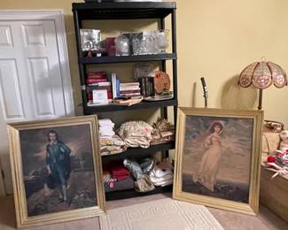 Full shelves of crystal and linens.  Vintage canvas Blue Boy and Pinkie paintings.