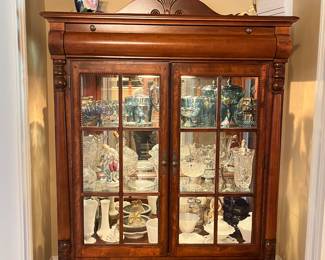 Beautiful display cabinet with glass doors and shelves, top and bottom drawers and decorative molding on top