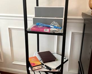         Uniquely shaped shelving unit and office supplies