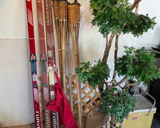 Vintage cross country skis, tiki torces, faux plant