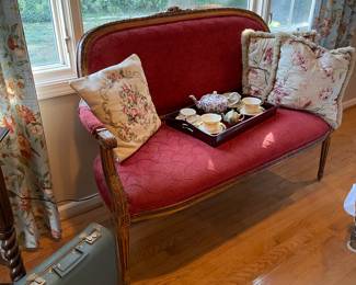 Settee with pillow and vintage suitcase