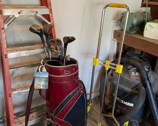Golf clubs, ladder and shop vac
