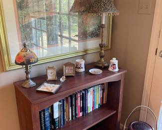 Bookcase, Asian urn, blown glass lamp, and framed print
