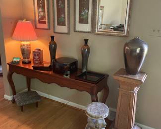 Wood stand, framed Asian prints, mirror, vases, Asian storage boxes, and porcelain lamp