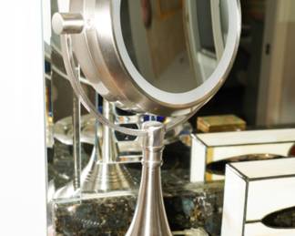 There are two lighted magnifying mirrors