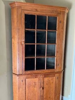 Check the website for the complete catalog and to start winning you bids! This is a southern pine three door corner china cabinet with plate rails. It has 12 panes of rolled glass in the top door.