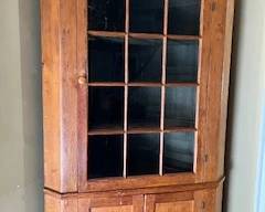 Check the website for the complete catalog and to start winning you bids!                                                                                         This is a southern pine three door corner china cabinet with plate rails. It has 12 panes of rolled glass in the top door.