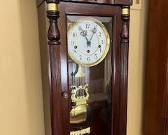 One of two Howard-Miller wall clocks