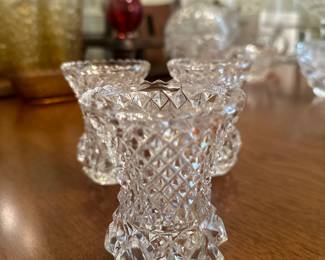 Trio of small diamond cut crystal vases.