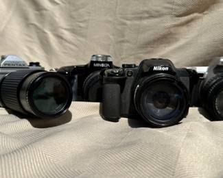 Variety of SLR cameras and lenses.