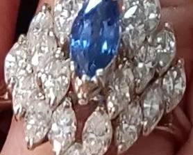 Ladies vintage diamond and sapphire ring. 7.2 grams of 18kt white gold with 3/4 carot natural blue marquise cut sapphire. 22 natural marquise shape white diamonds 3 cts. Appraised in June of 2024 at $5875 at Fountain City Jewelers.
